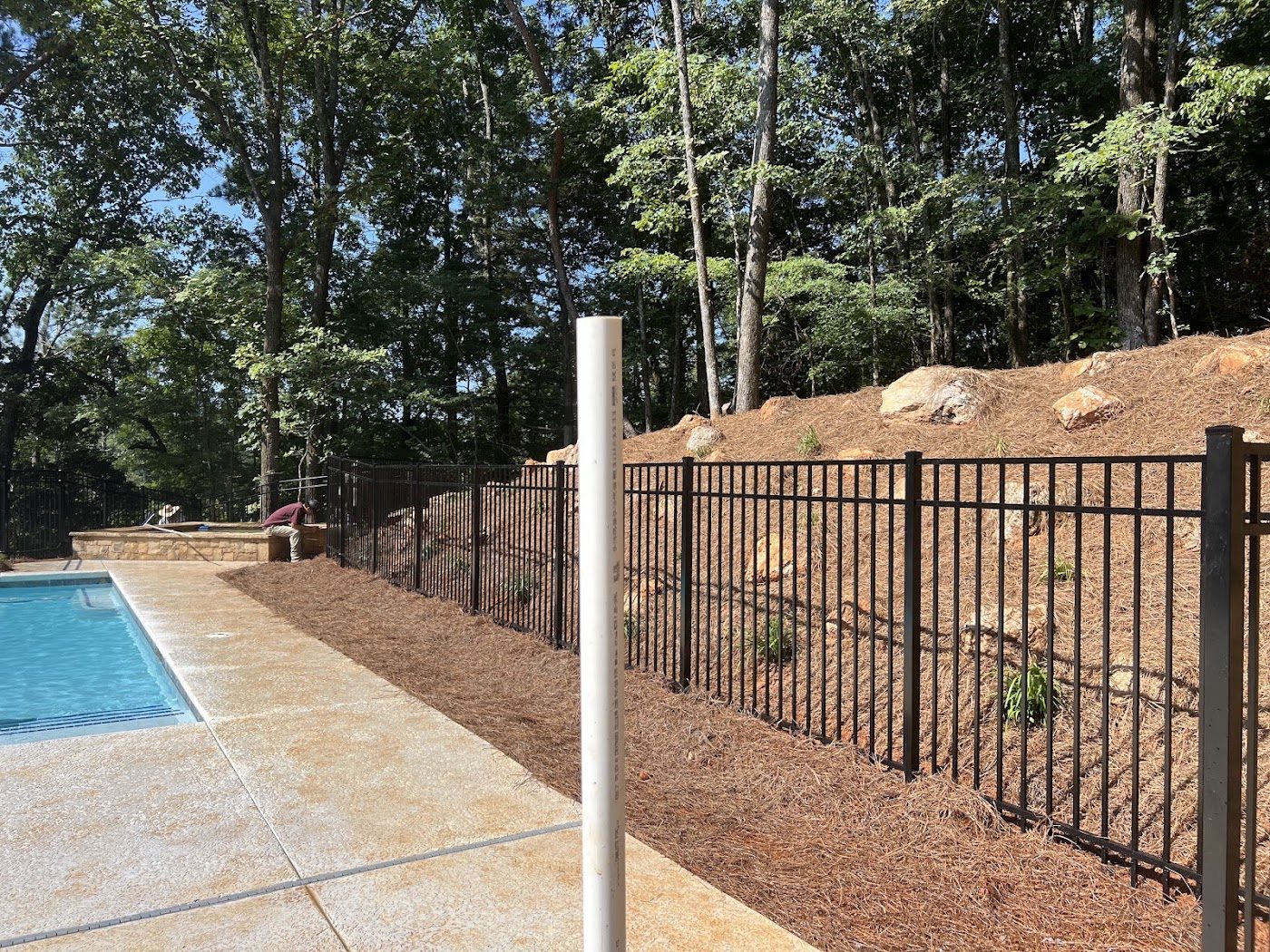 Black metal pool fence installed by Ramirez Fencing